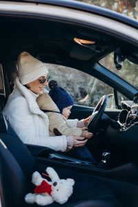 Mother with son sitting by the wheel